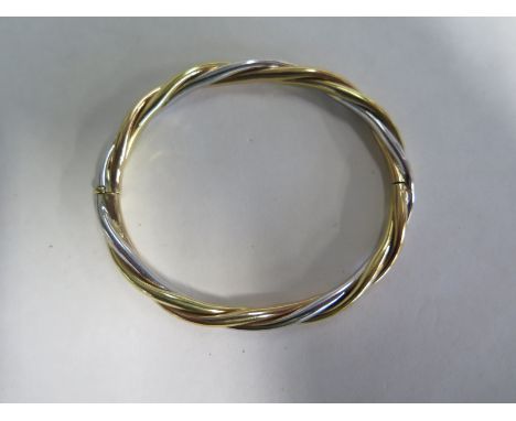 A 9ct tri colour bangle marked 9K Italy - 6cm x 7cm - approx 18.6 grams - in good condition - minor usage marks 