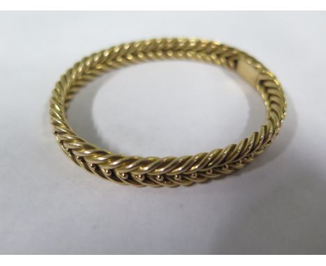 A gilt metal bangle, tests to approx 9ct, approx 14 grams, some wear, otherwise in good condition 