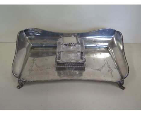 A silver desk stand with single glass inkwell, hallmarks for London 1908/09 maker WC 29cm wide, approx 19 troy oz, generally 