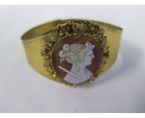 A gilt metal Cameo bangle, damage to Cameo, bangle 7cm wide 
