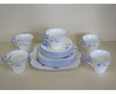 A part Shelley tea service with five tea cups, six saucers, five side plates, and a square serving dish - generally good cond