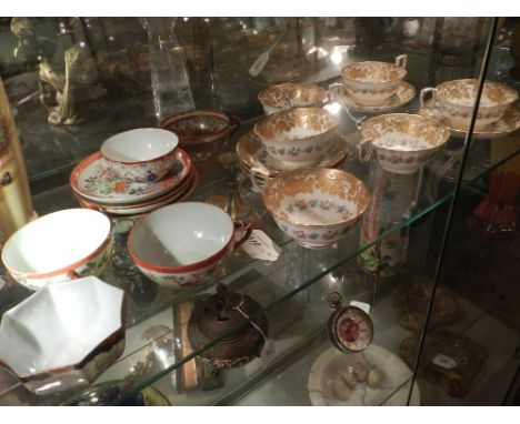 A collection of early 20th century Japanese eggshell porcelain, some marked to base, decorated with various patterns in red a
