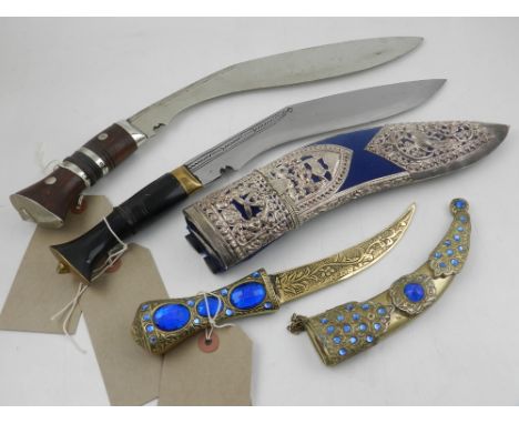 A Middle Eastern dagger, bone handled, in a blue velvet and white metal scabbard, together with two other scabbards 