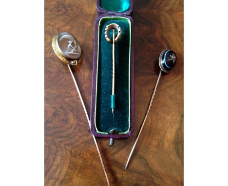 Three 19th c stick pins inc, shell cameo and 18ct horse shoe