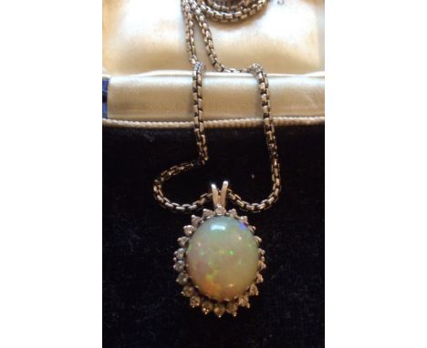 Opal and dianond cluster pendant set in white gold, 22 diamonds totalling 0.66 carats, opal 5.64 carat, opal A/F.