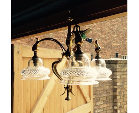 Hanging brass light fitting with three cut glass shades.