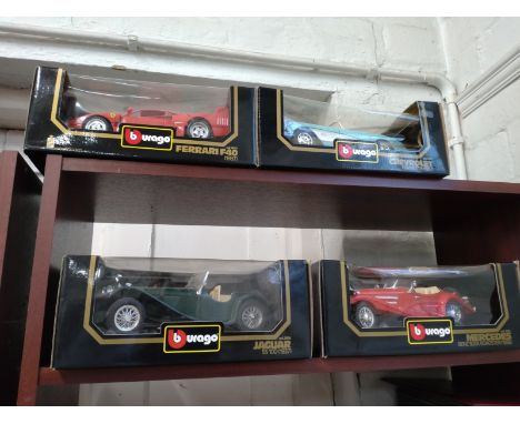 Burago 1/18 scale 1957 Chevrolet Corvette, Ferrari F40, Jaguar SS100, and Mercedes-Benz 500K in window boxes. 