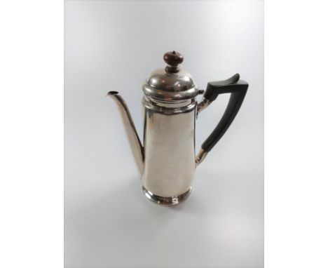 A silver coffee pot of plain form. London. By Mappin &amp; Webb.