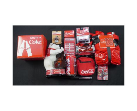 A nostalgic 12-piece collection of Coca-Cola memorabilia including a battery-operated plush bear playing a bass fiddle, weari