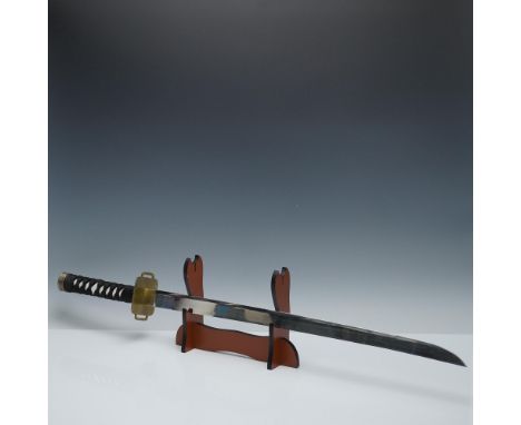 This lot features a Japanese-style katana sword presented with a black lacquered scabbard and a matching wooden display stand