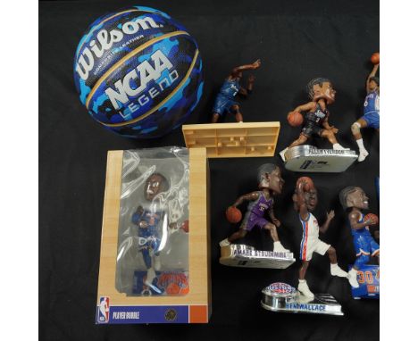 A diverse 13-piece NBA-themed collection featuring a Wilson NCAA Legend basketball in blue camouflage pattern, a framed LeBro
