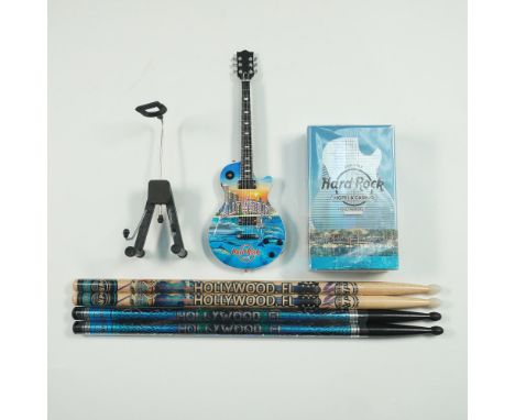 Rockstar lot includes a Hard Rock Hotel Hollywood, FL-themed mini guitar with stand, branded fragrance (Made in France), and 