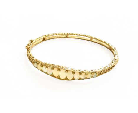 A 9 Carat Gold Opal Hinged Bangle, inner measurements 5.7cm by 5.1cmGross weight 11.2 grams.
