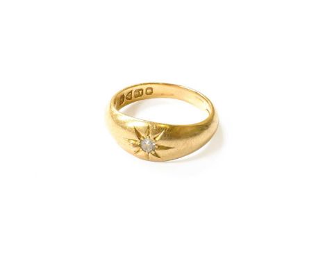 An 18 Carat Gold Diamond Solitaire Ring, the old cut diamond in a yellow star setting, to a plain polished shank, finger size