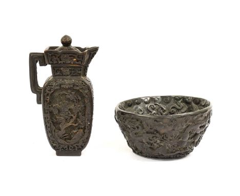 A Chinese Ewer, Cover and Basin, the ewer of flattened ovoid form carved with flowering branches in panels on a foliate groun