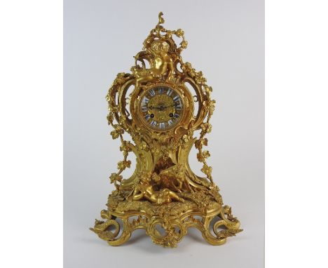 A Louis XV style ormolu mantel clock with 3.5 inch dial, signed to the centre 'Journeux A Paris', within a ring of Roman nume