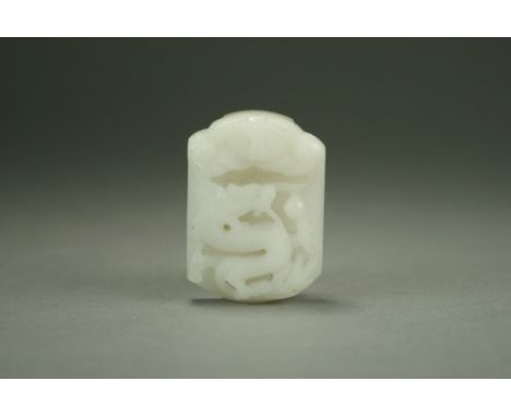 A Chinese near white jade buckle, Qing Dynasty, of rectangular form with slightly rounded ends, carved in relief with a drago