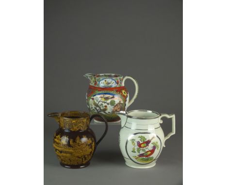 Three mid-19th century English pearlware jugs, the first enamelled with parrots within silver lustre decoration, 14.5cm high,