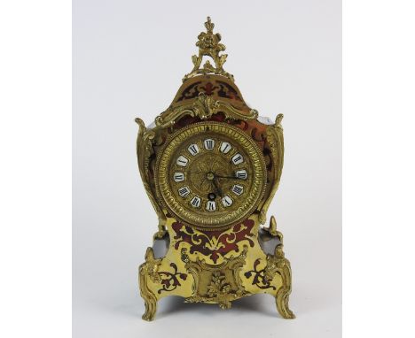 A late 19th century French boulle style mantel timepiece, the 3.25 inch dial with ring of enamel Roman numeral cabochons, und