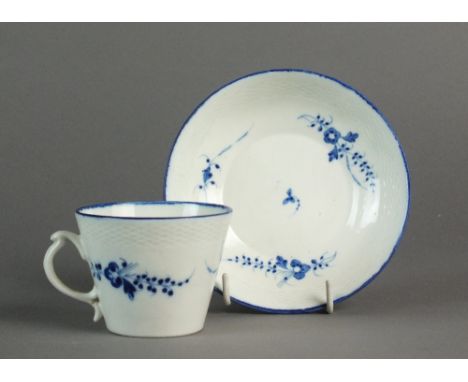 A Caughley coffee cup and saucer with basket weave moulding, painted with the Chantilly Sprigs B pattern, circa 1785-92, S ma