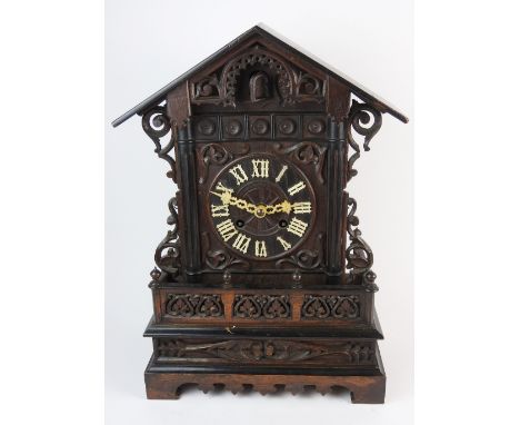 A late 19th century stained oak cuckoo mantel / bracket clock, the 6 inch dial with ring of Gothic Roman numerals under a poi