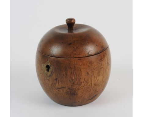 An 18th century style fruitwood tea caddy in the form of an apple the hinge lid opening to reveal a silvered interior, 11cm h