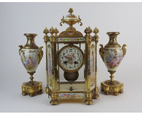 A 20th century clock garniture, the 3.5 inch dial with ring of Arabic numerals centred by a printed scene of putti and motif 