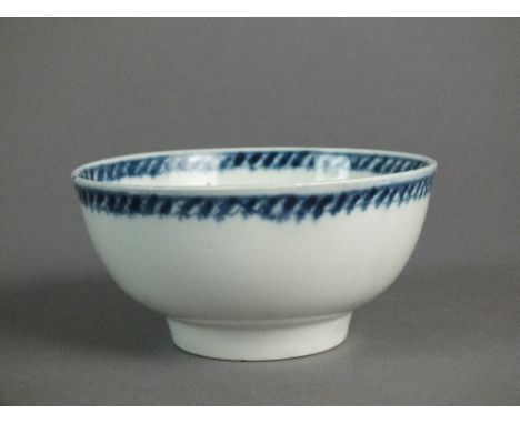 A small Caughley bowl painted with a Single Flowerheard, circa 1776-78, with a dash and half filled oval border to inside rim