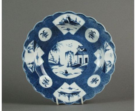 A Caughley plate painted with a fan-panelled landscape within powder blue ground, circa 1777-85, impressed Salopian and paint