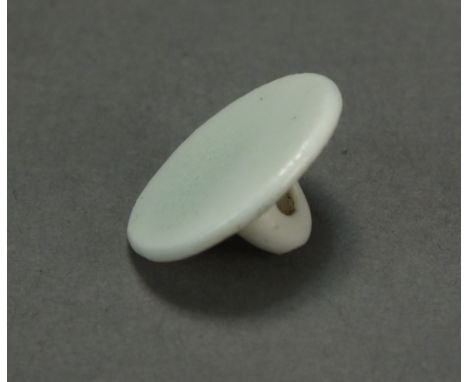 A Caughley button, of small size, with flat face and thread hole to rear, glazed and undecorated and unmarked, circa 1785-95,