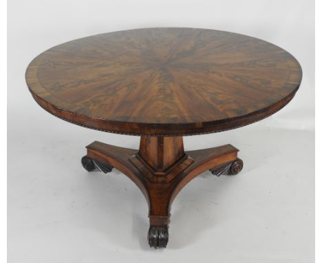 A William IV mahogany and rosewood crossbanded circular centre / dining table, the top with radiating veneers over a plain fr