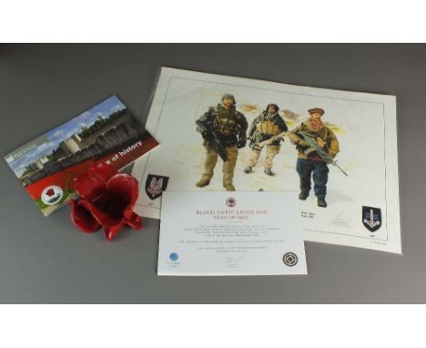 A ceramic poppy designed by Paul Cummins for the Tower of London display, with a certificate of authenticity and original box