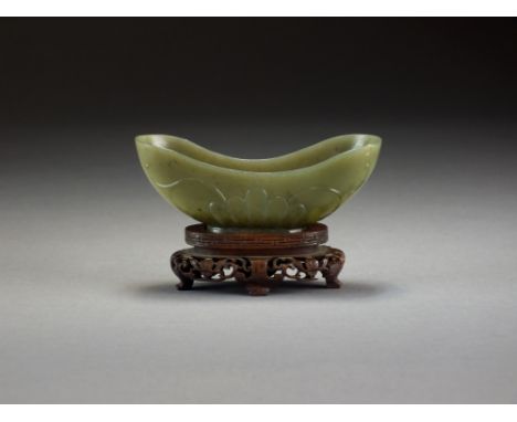 A Chinese dark green jade brush washer, Qing Dynasty, in the form of a lotus flower with trailing buds, with carved hardwood 