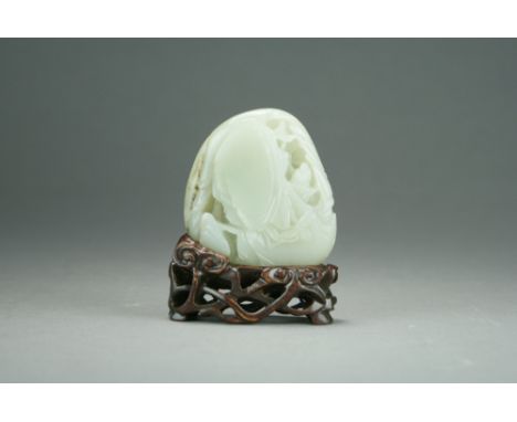 A Chinese pale celadon jade carving, late Qing Dynasty, modelled as a scholar seated in a rocky mountain retreat, with carved