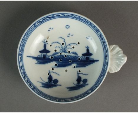 A Caughley egg drainer painted with the Island pattern, circa 1780-90, with an associated segmented border, S mark, 8.2cm dia