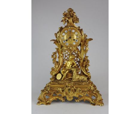 A late 19th century Louis XV style ormolu mantel clock, the 3.5 inch dial of Roman numerals in a drum case with summer bloom 