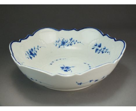 A Caughley moulded salad bowl painted with the Bright Sprigs pattern, circa 1780-90, 27.9cm wide (firing fault to the bottom 