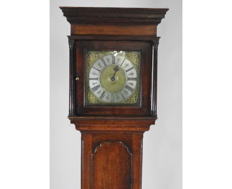 An 18th century oak thirty hour longcase clock, the 11 inch dial with ring of Roman numerals, the hood with turned front corn