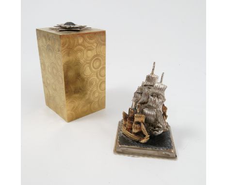 A Stuart Devlin silver and silver gilt surprise Christmas carol present, of rectangular form, opening to reveal an enamel and