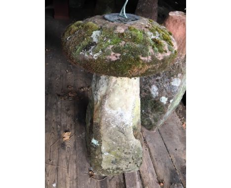 A staddle stone and cap, the cap with a sundial