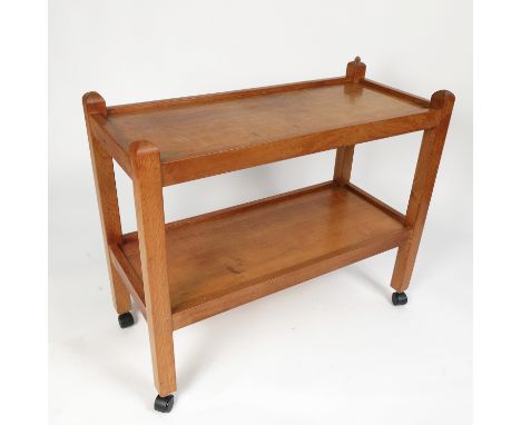 A Robert Thompson of Kilburn "Mouseman" light oak tea trolley, having two tiers raised on four square section legs, 15ins x 3