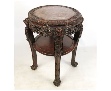 A Chinese padouk jardiniere stand, having marble inset, with carved frieze, raised on four carved legs, with shelf below, dia
