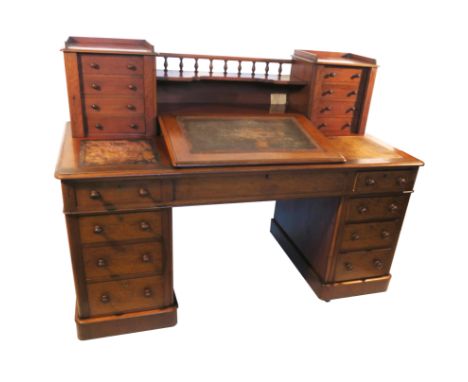 A 19th century mahogany writing desk, having a central slope with galleried shelf over, flanked by two Wellington locking che