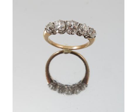 A five stone diamond ring, unmarked, the graduated old brilliant cuts totalling approximately 1.6 carats, finger size N 1/2, 