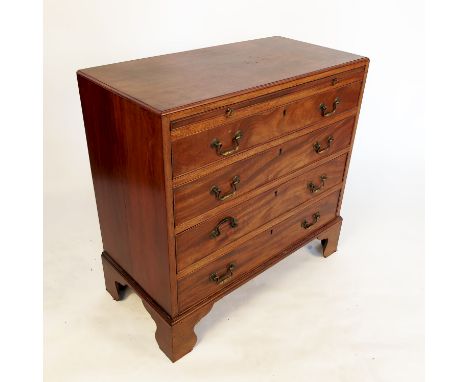 A 19th century mahogany chest of drawers, fitted with a writing surface over four graduated long drawers, raised on bracket f