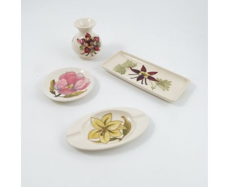 Four pieces of Moorcroft Pottery, a vase, a rectangular dish, a circular dish and an oval ashtray, all decorated with differe