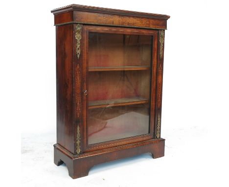 A Victorian walnut pier cabinet, having glazed door with marquetry and gilt metal mounts, raised on bracket feet, width 30ins