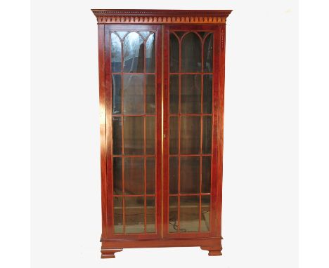 A Georgian design free standing mahogany bookcase, with astragal doors with boxwood and ebonised line inlay, opening to revea