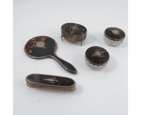 A silver and tortoiseshell oval ring box, with inlaid silver decoration to the tortoiseshell panel, lined interior and raised