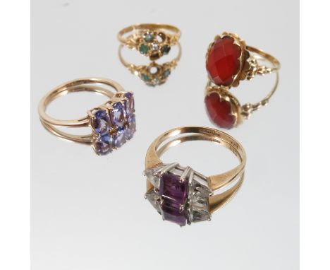 An amethyst and cubic zirconia 9 carat gold ring, with a 9 carat gold three stone Tanzanite ring, 3.4g gross, a Cornelian rin